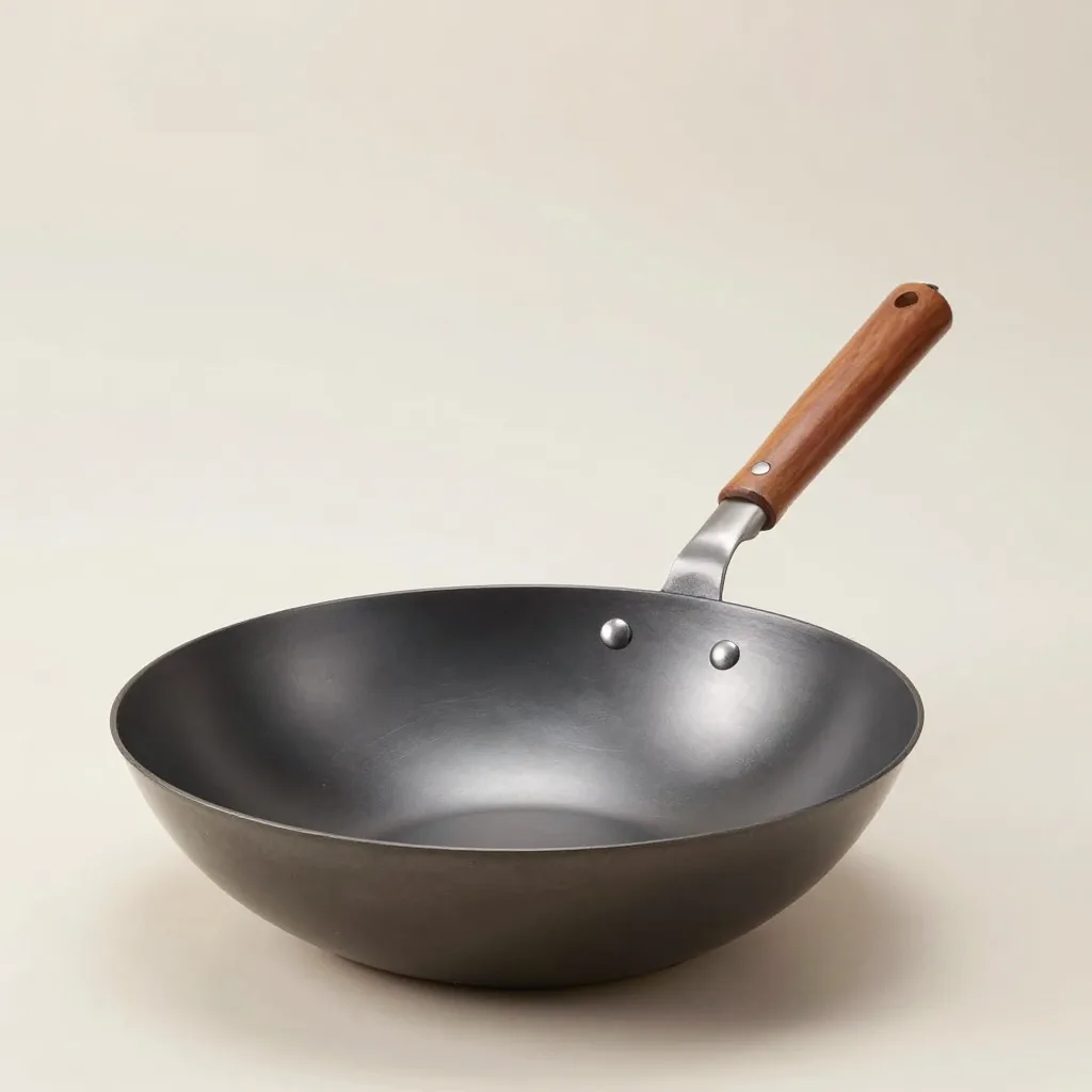 A carbon steel wok ladle